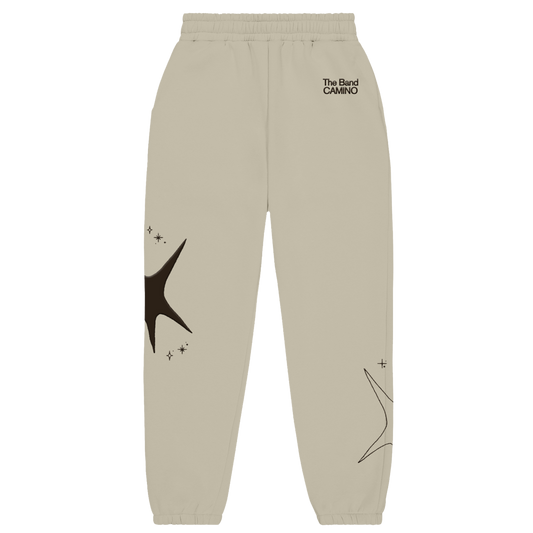 Beige sweatpants with star designs and text on a white background